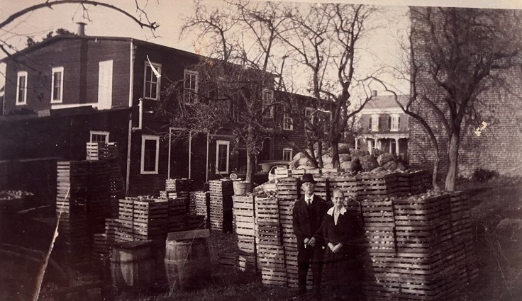 John and Catharine Bauman outside factory